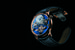 Первые часы Legacy Machine № 2 появились в арсенале MB&F в 2013 году, и с тех пор эта модель получила несколько вариаций. Ее новая версия создана из розового золота, а циферблат впервые обрел насыщенный синий цвет: узор «солнечные лучи» на нем получен посредством процесса химического осаждения из паровой фазы (CVD). Также версия LM2 Red Gold Blue предлагает элегантную интерпретацию эстетики часов, из всех версий максимально близкую к оригиналу. Два парящих баланса со спусковыми механизмами, подвешенные на четырех изогнутых арках с левой и правой сторон, представляют зеркальное отображение друг друга