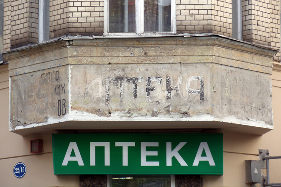 Вывеска «Аптека» и «Центральное бюро студенческих кооперативов» (1920-е годы) до реставрации. Малая Бронная улица, дом 22